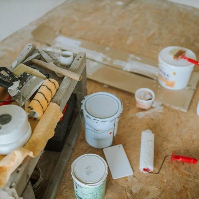 Overhead shot of tools and paint supplies for a home renovation project.